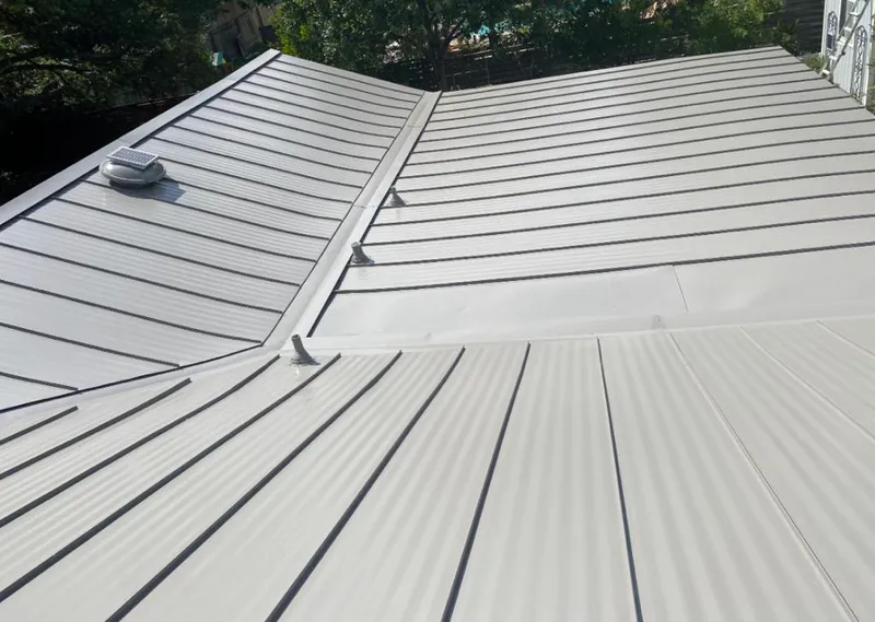 Solar attic fan installed on a metal roof for Roof Ventilation in Peculiar
